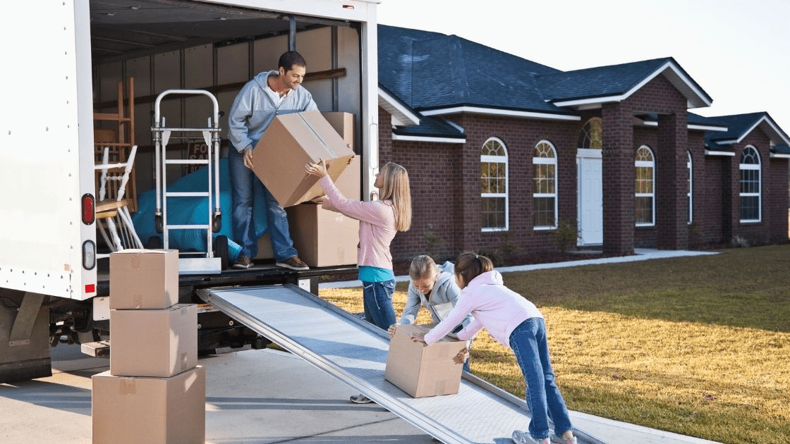 A family loading a U-Haul truck for a long distance move