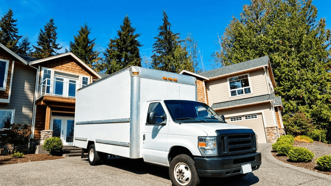 An image of a moving truck parked in front of a house on moving day