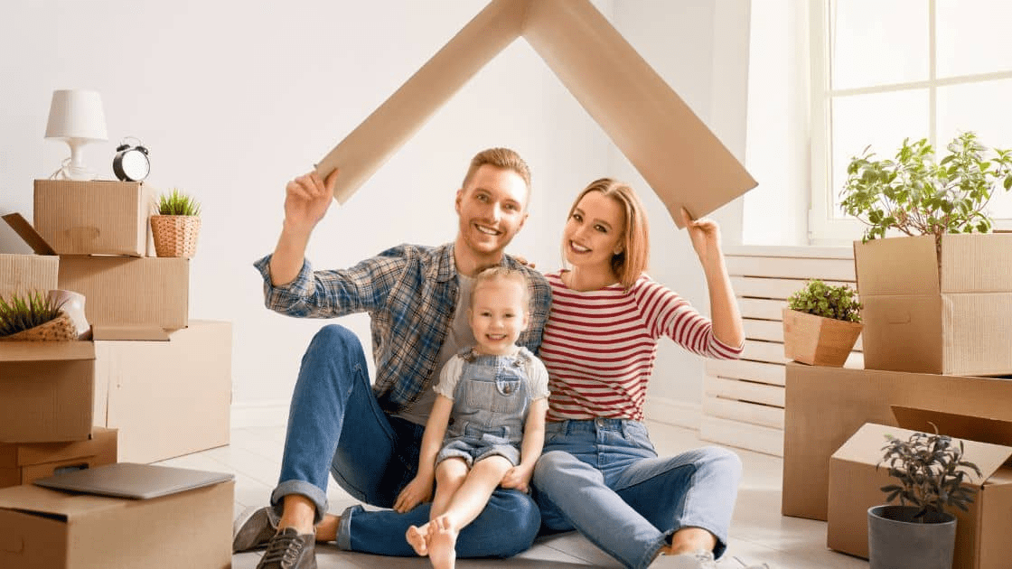 A family unpacking on their new house, smiling and happy